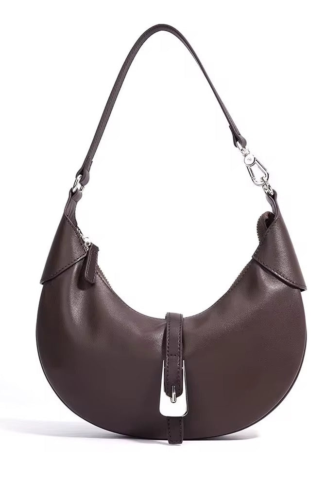 Brown leather handbag with a silver buckle on a white background