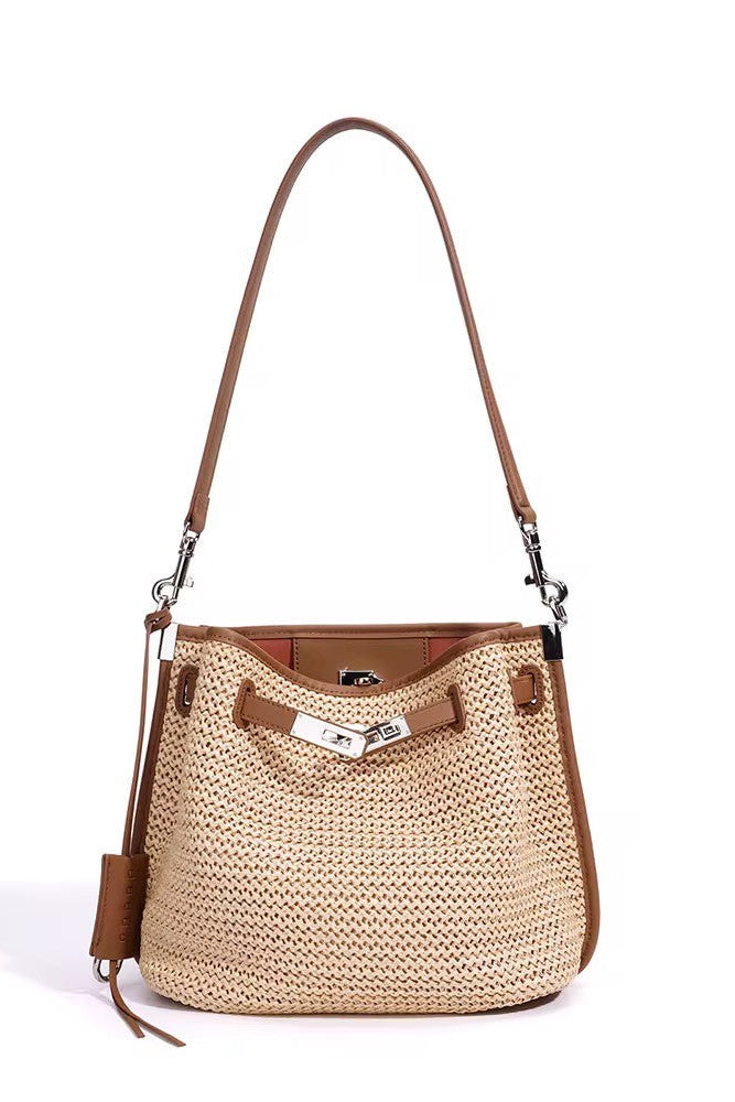 Beige woven handbag with brown leather accents on a white background