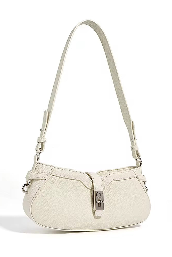 White handbag with a strap on a white background