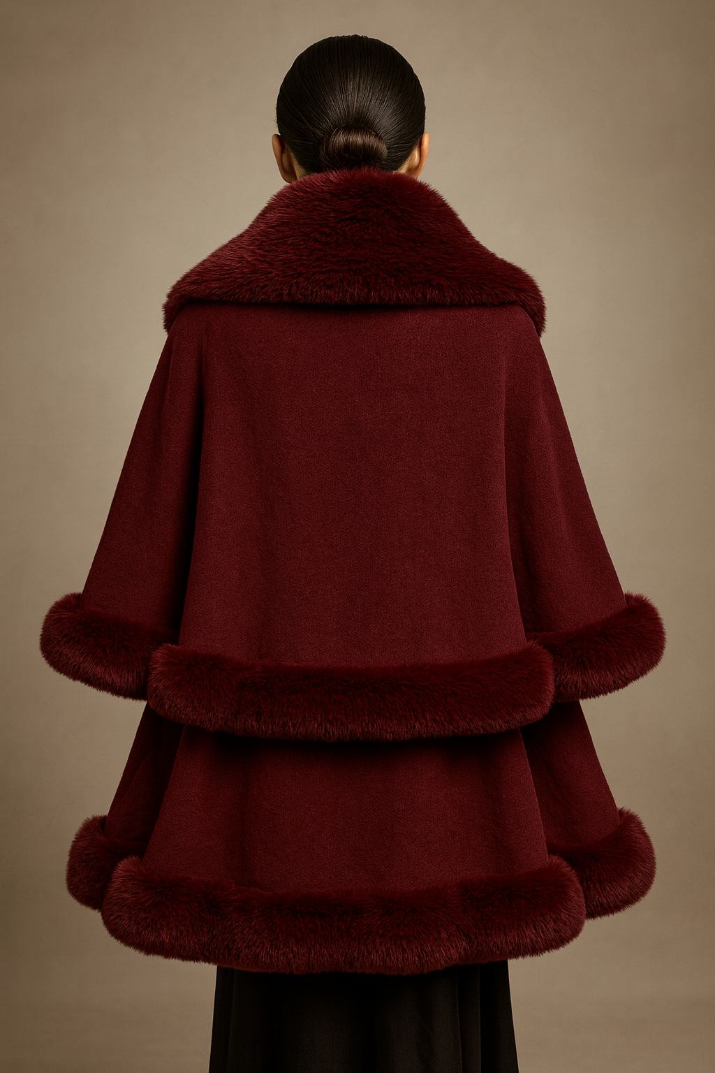 Burgundy cape with fur trim on a neutral background