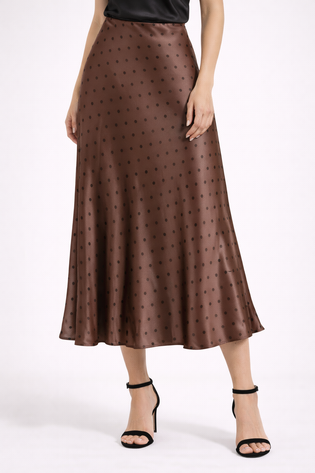Brown polka dot skirt worn by a person on a white background