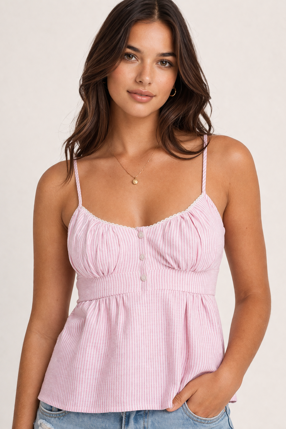 Woman wearing a pink striped top against a plain background