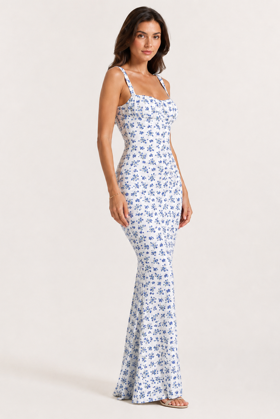 Woman wearing a floral dress on a plain background