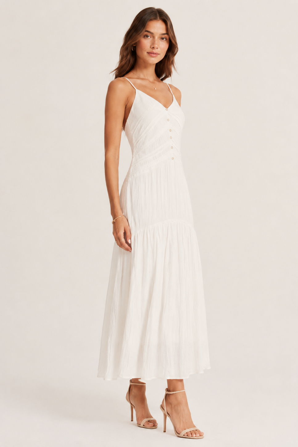 Woman wearing a white dress against a plain background
