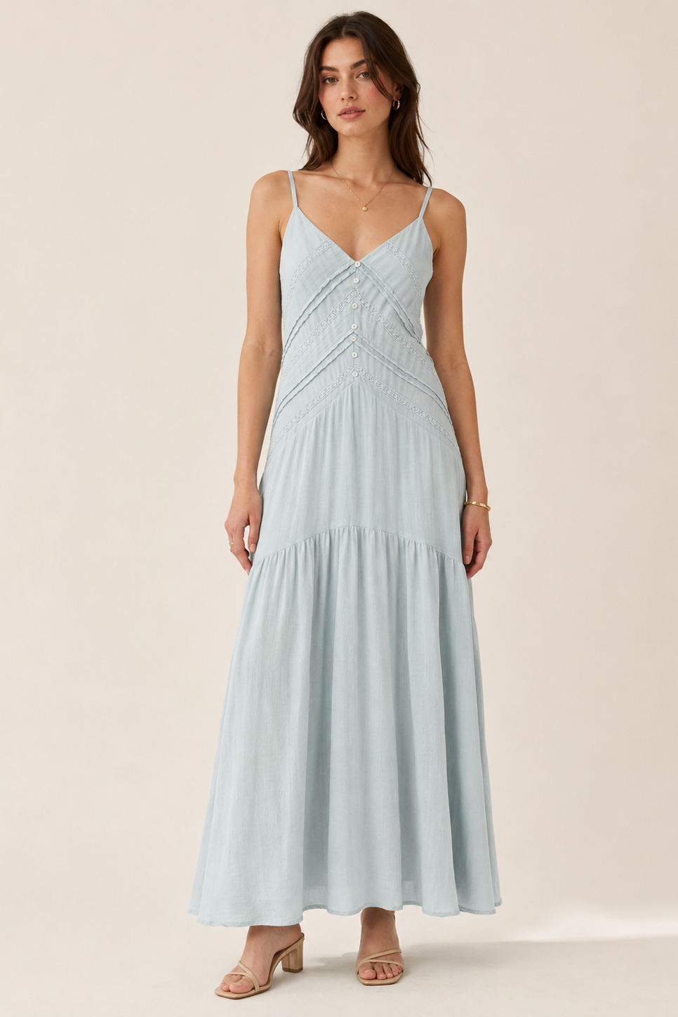 Woman wearing a light blue dress on a beige background