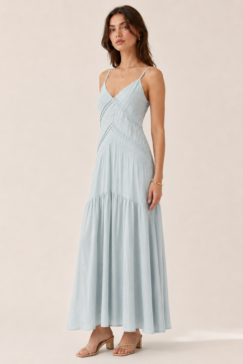 Woman wearing a light blue dress against a beige background