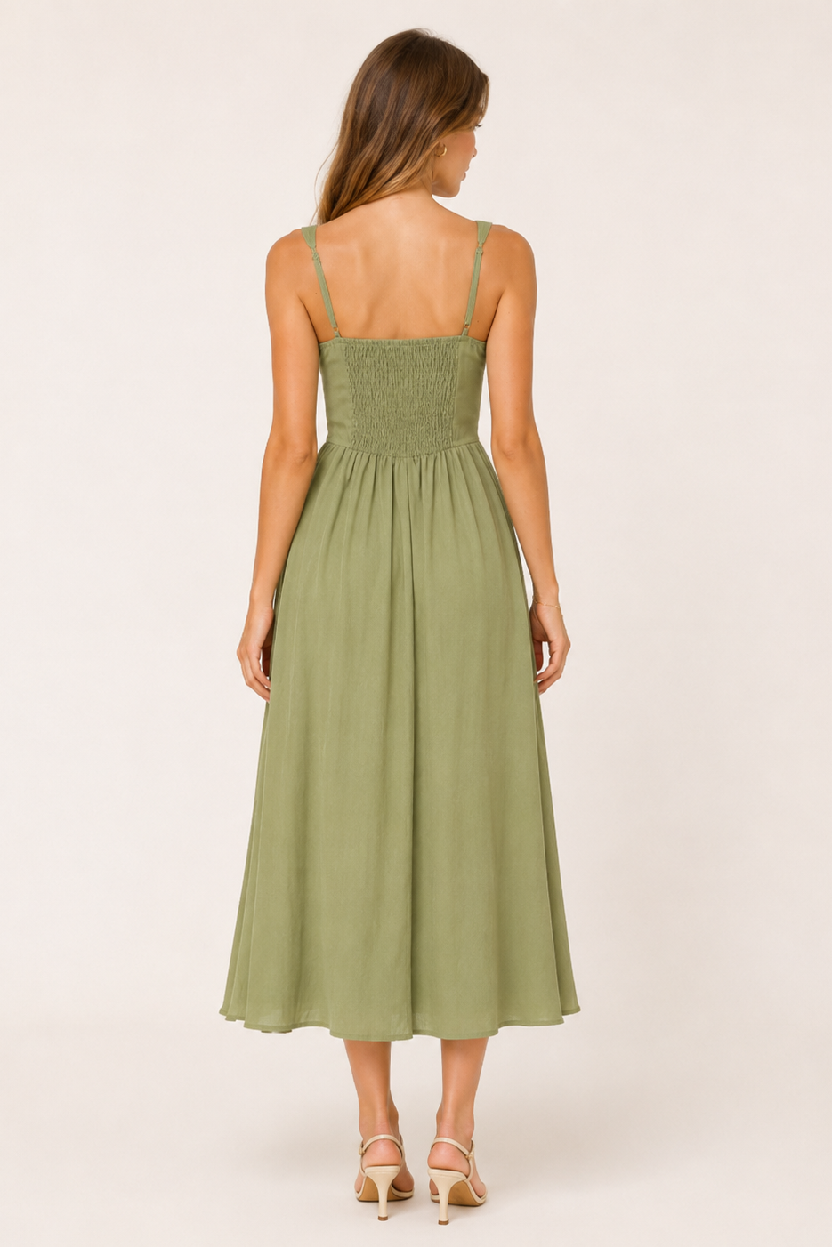 Woman wearing a green dress on a white background