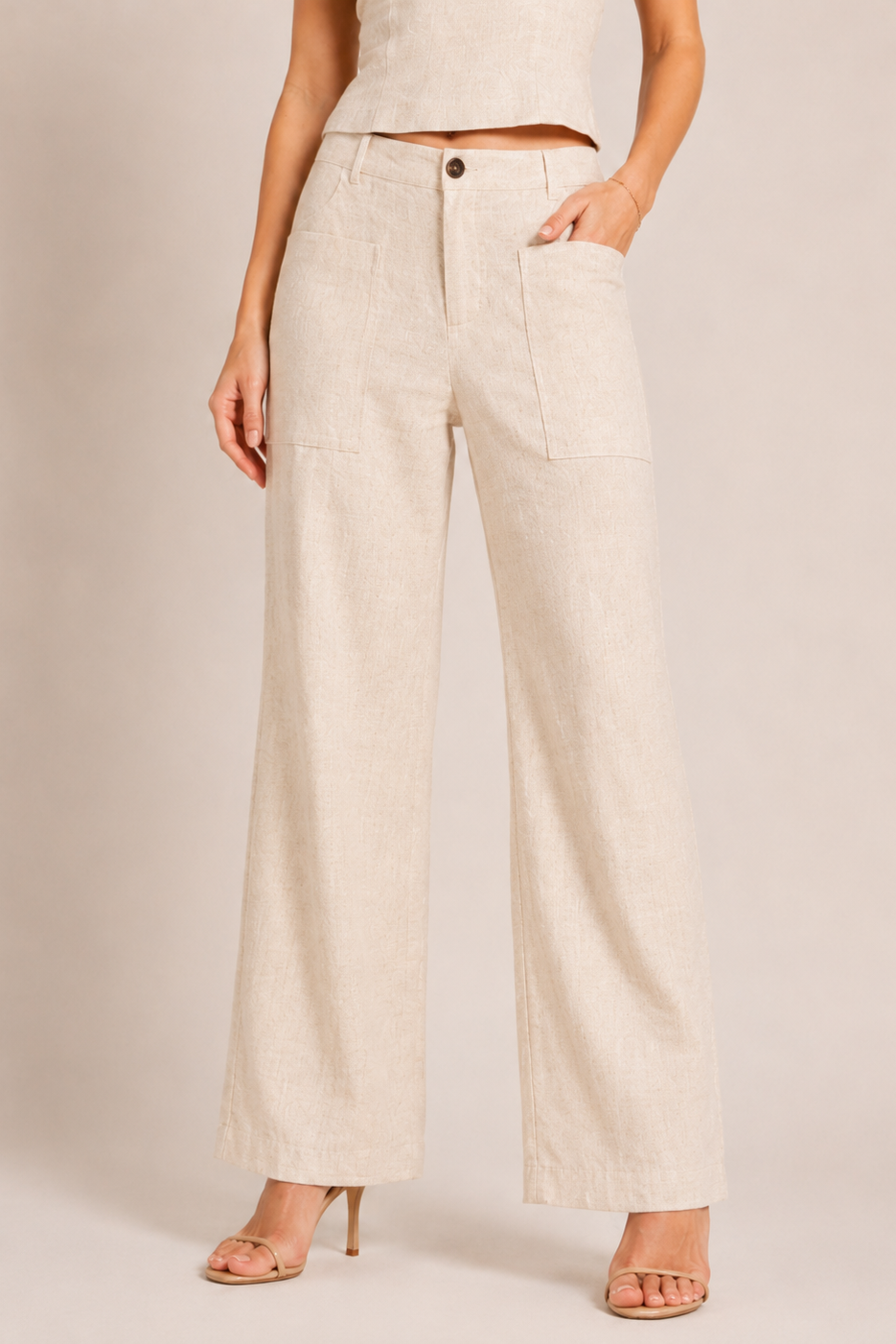 Beige wide-leg pants worn by a person on a plain background