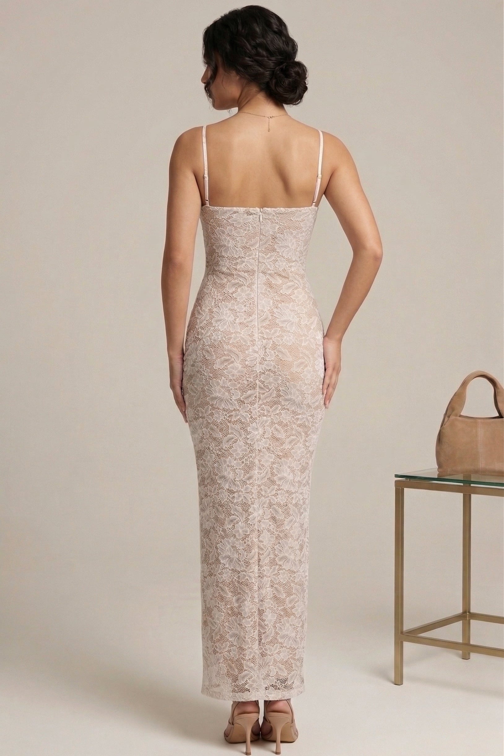 Woman wearing a lace dress with a beige background