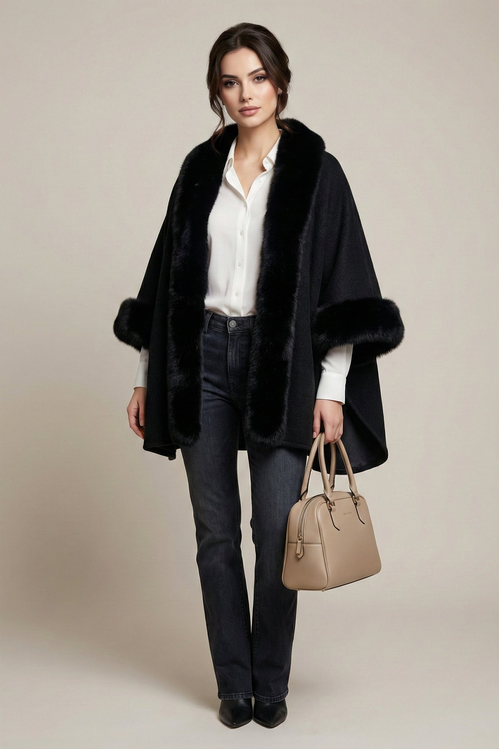 Woman wearing a black fur-trimmed coat with a beige handbag on a neutral background
