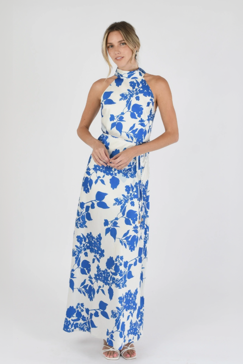 Woman wearing a blue floral dress on a white background