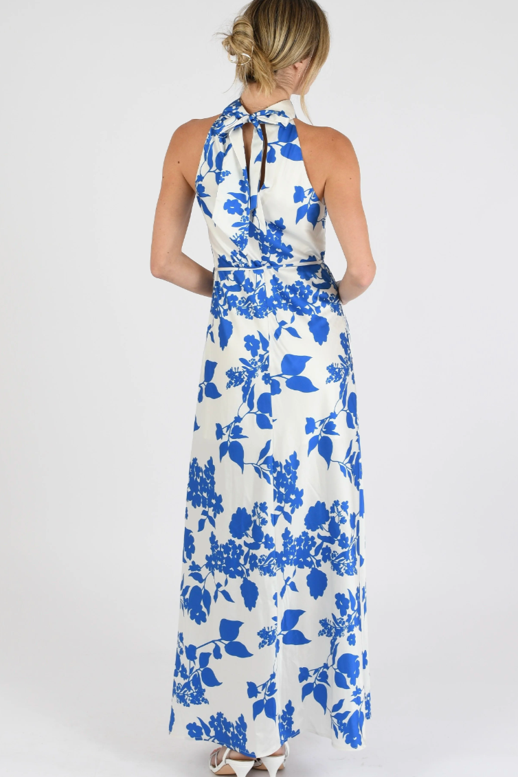 Woman wearing a blue floral dress on a white background