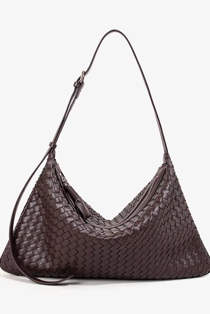 Brown woven handbag on a white background
