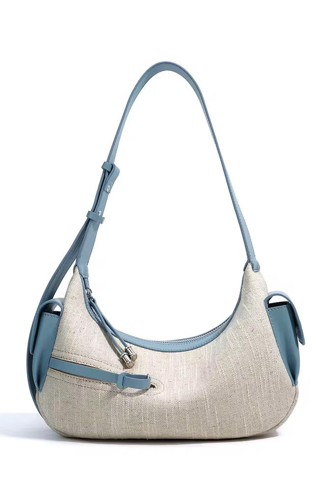 Beige handbag with blue accents on a white background