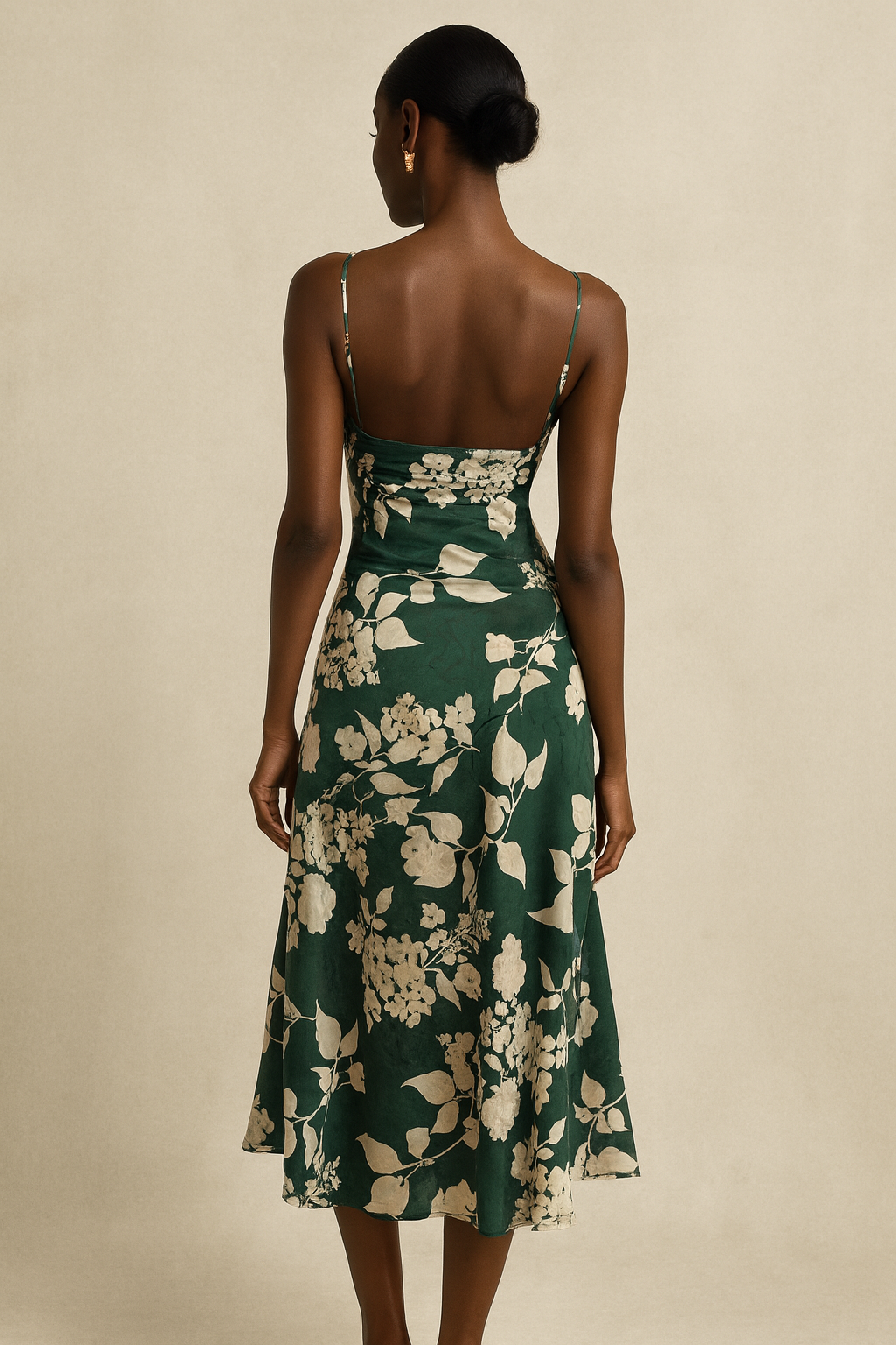 Woman showing back of green floral midi dress