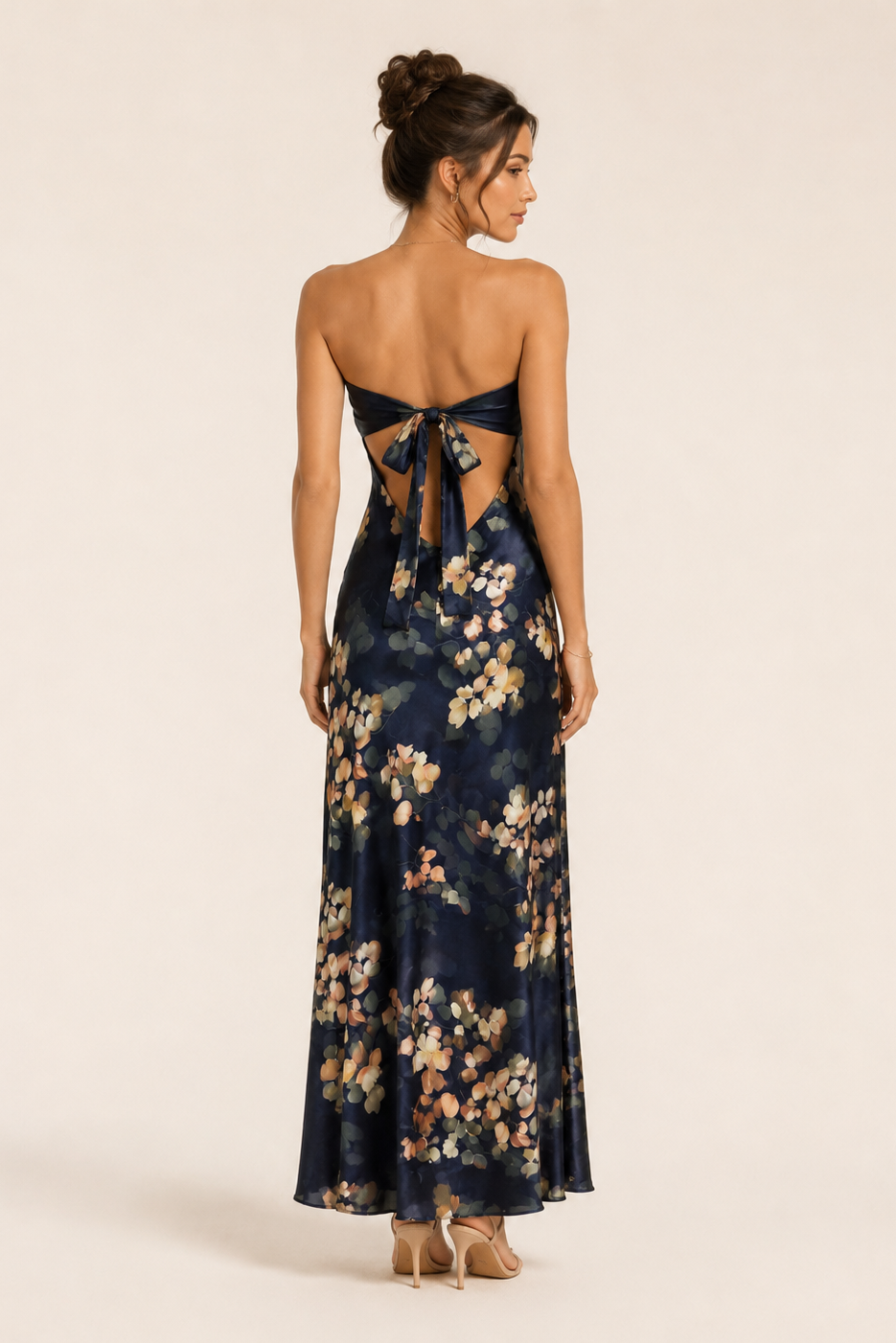 Woman wearing a floral dress with cut-out back on a beige background