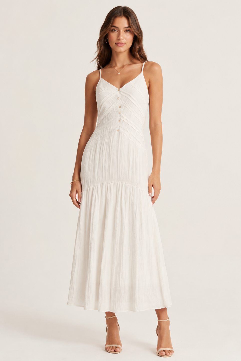 Woman wearing a white dress on a plain background