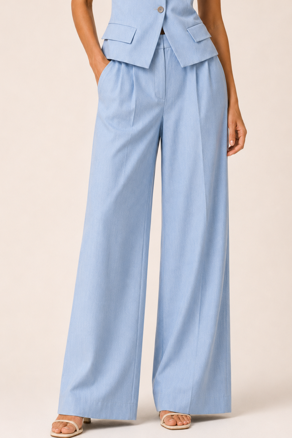 Light blue suit with wide-leg pants on a beige background