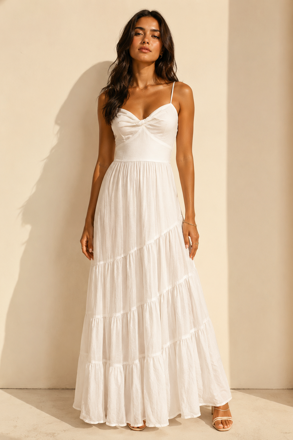 Woman wearing a white dress against a beige background