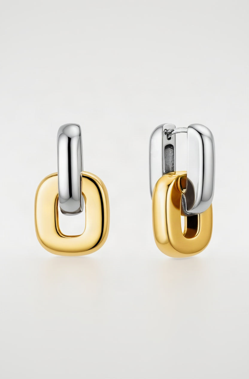 Pair of gold and silver hoop earrings on a white background