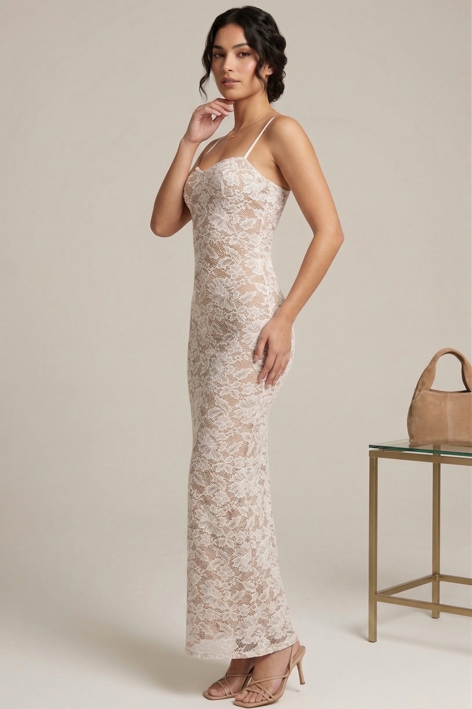 Woman wearing a lace dress with a beige background