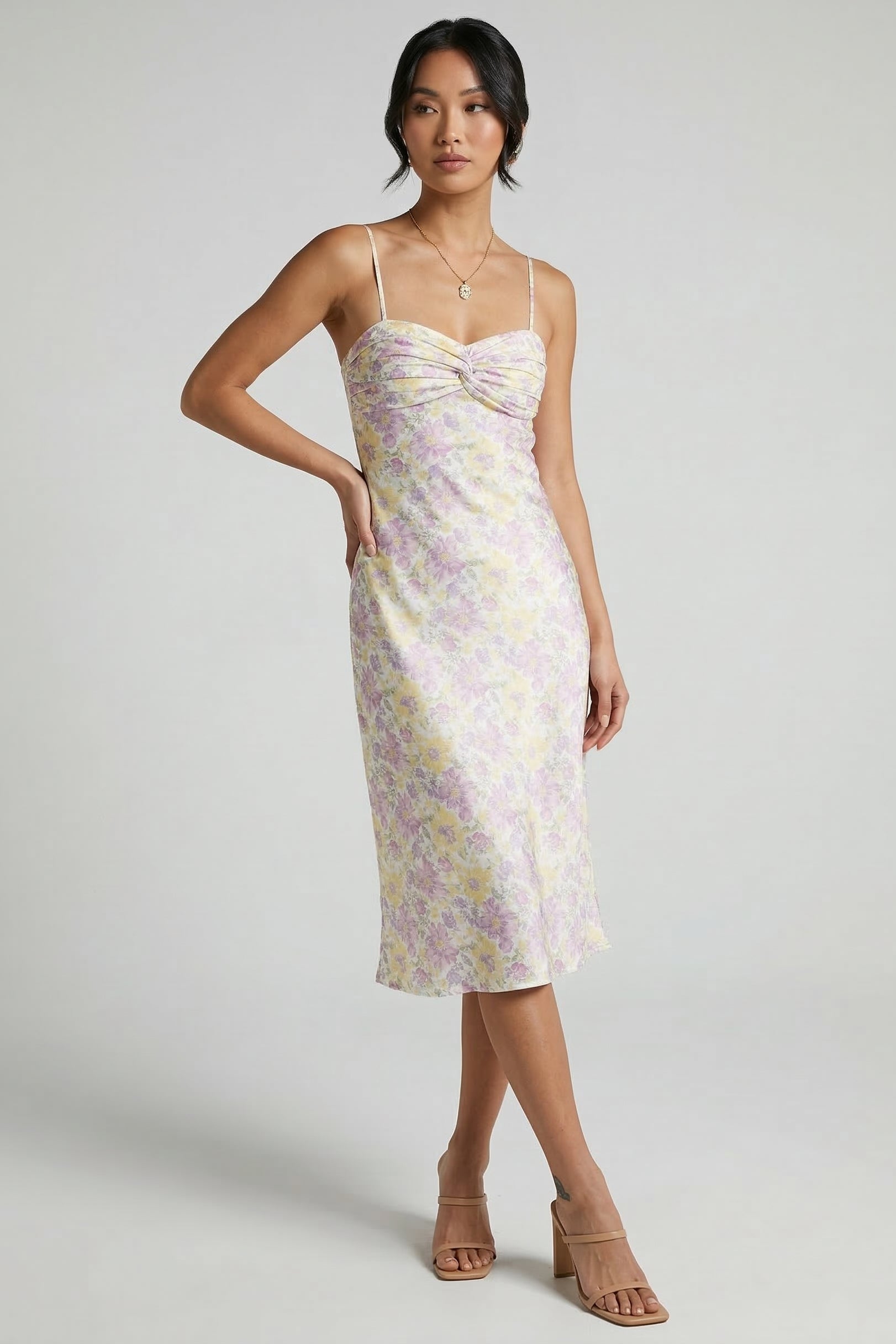 Woman wearing a floral dress on a plain background