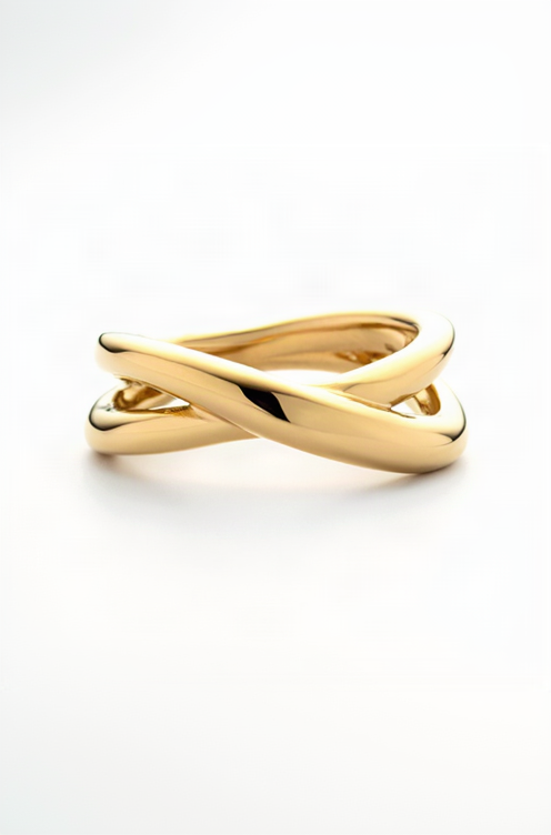 Gold ring with a twisted design on a white background