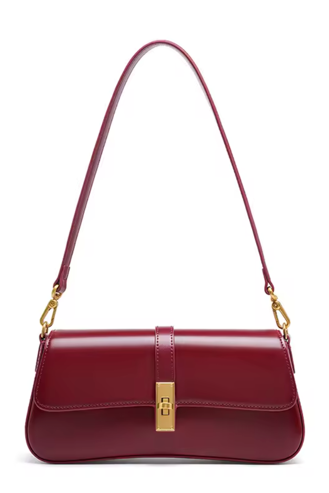 Red handbag with gold accents on a white background