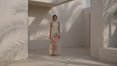 Woman modeling butter yellow  floral maxi dress with beige architecture 